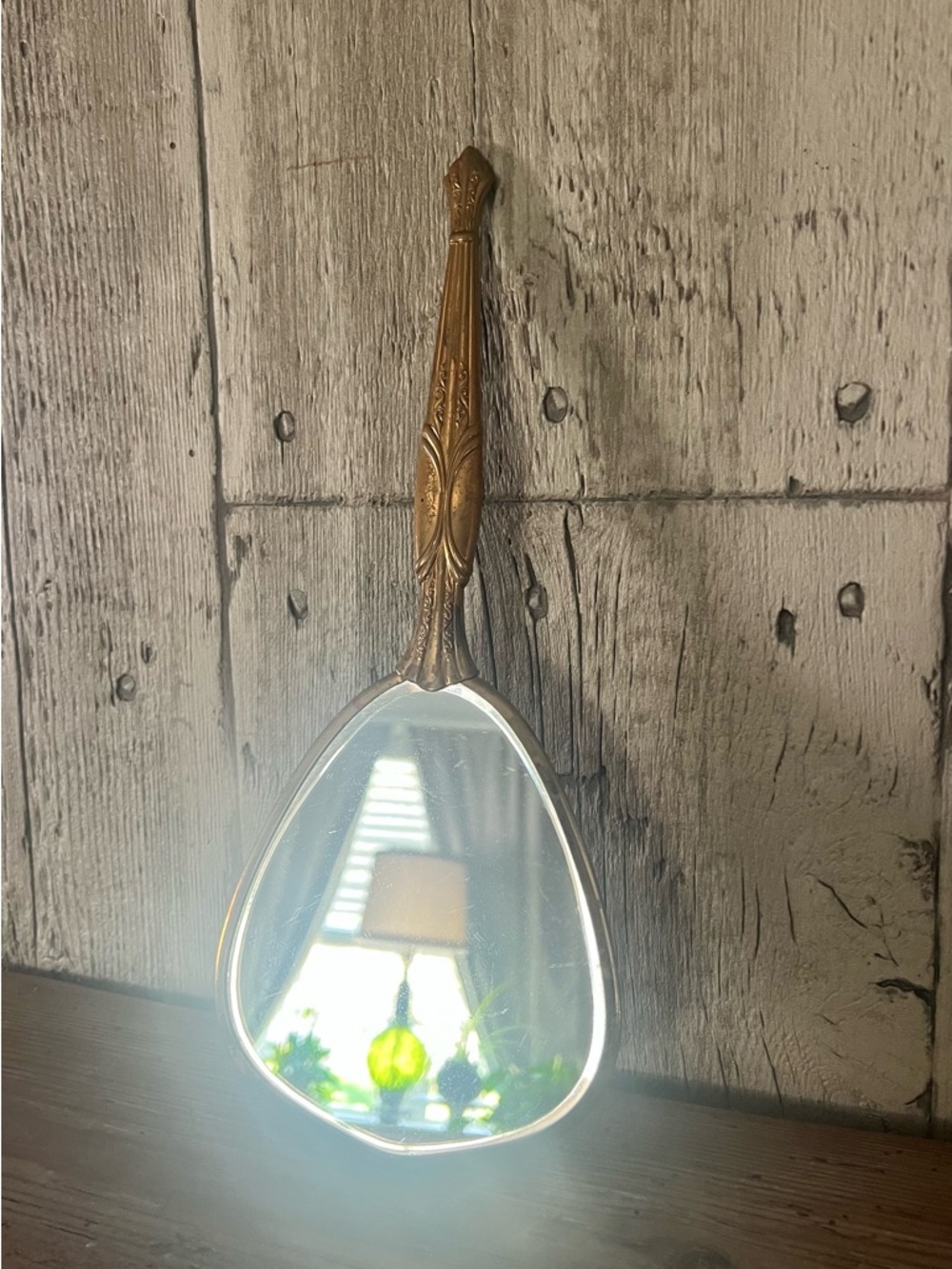 Antique gold metal hand held mirror